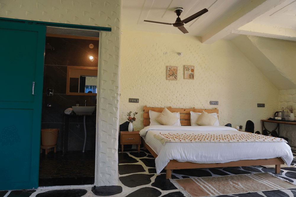 Bedroom with ceiling fan and framed art