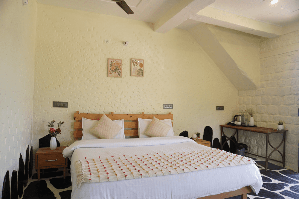 Double bed against a stone-textured wall