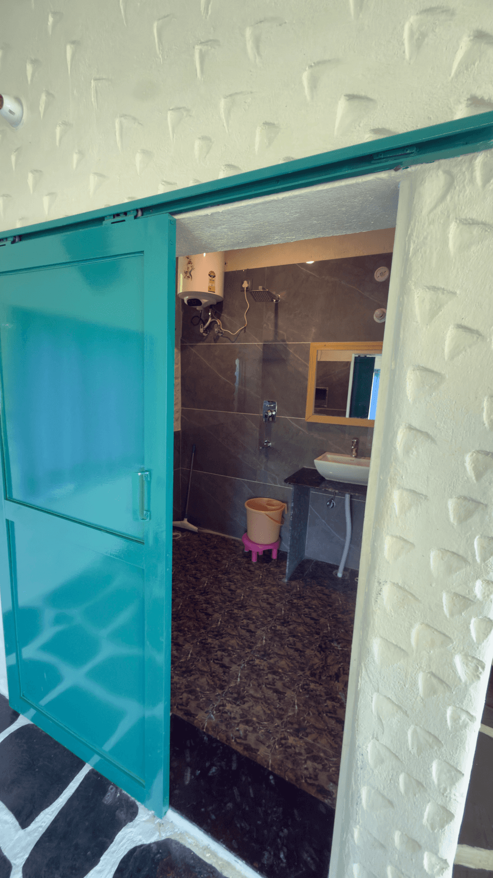 Sliding teal door to the bathroom