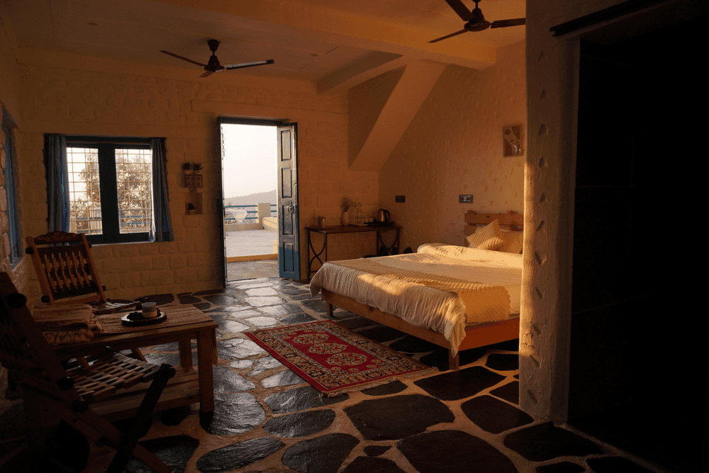 Bedroom in golden light with the terrace door open