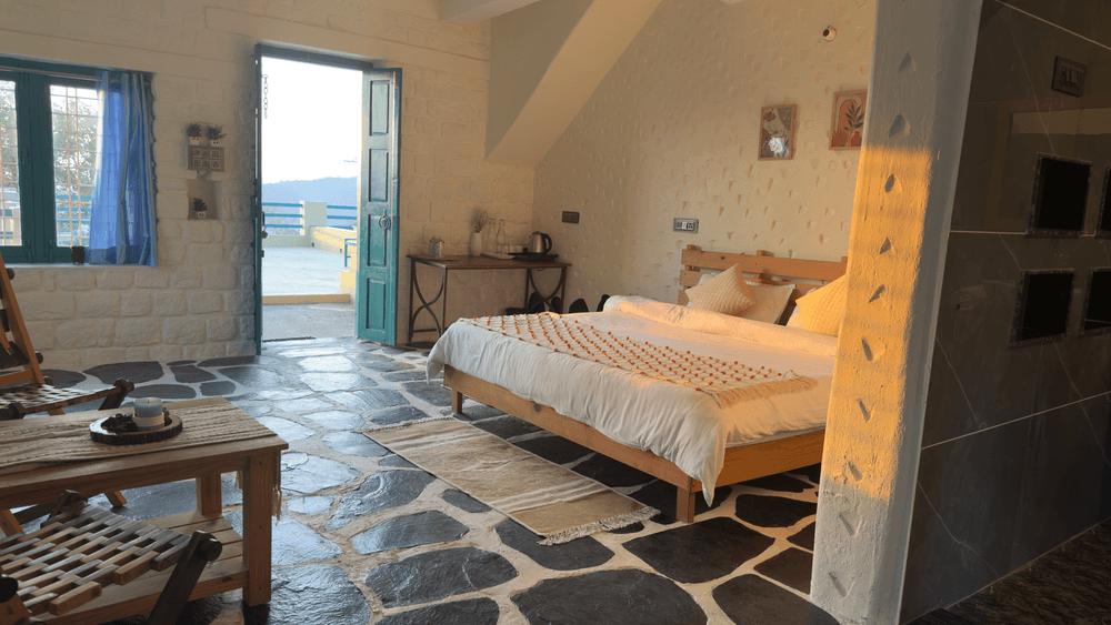 Bed, sitting chair and the view through the open doors