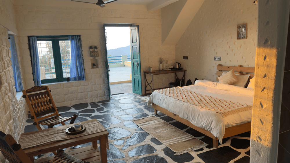 Room with a wooden armchair and the terrace door open