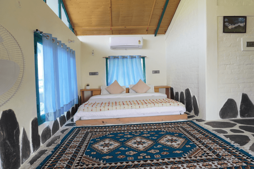 Bed and large windows under the sloping roof