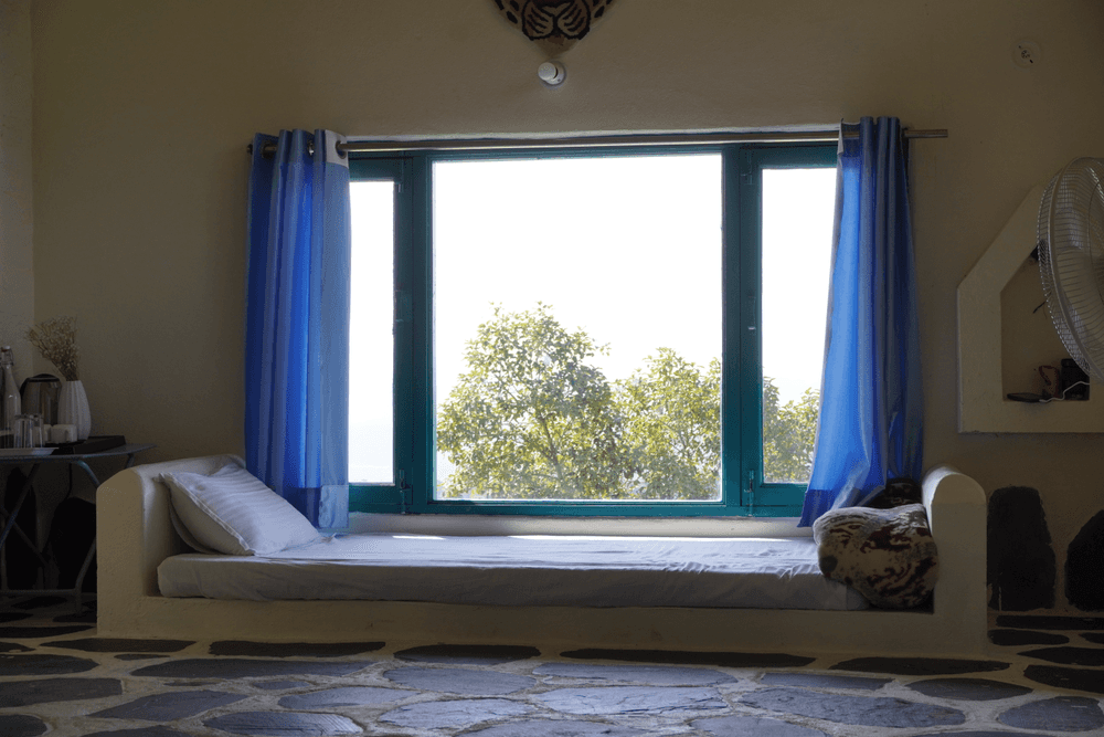 Window daybed framing the trees and hills