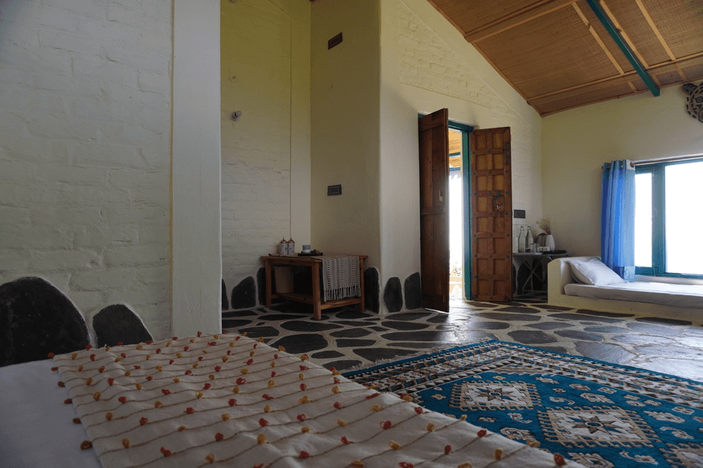 The room seen from the bed towards the wooden doors