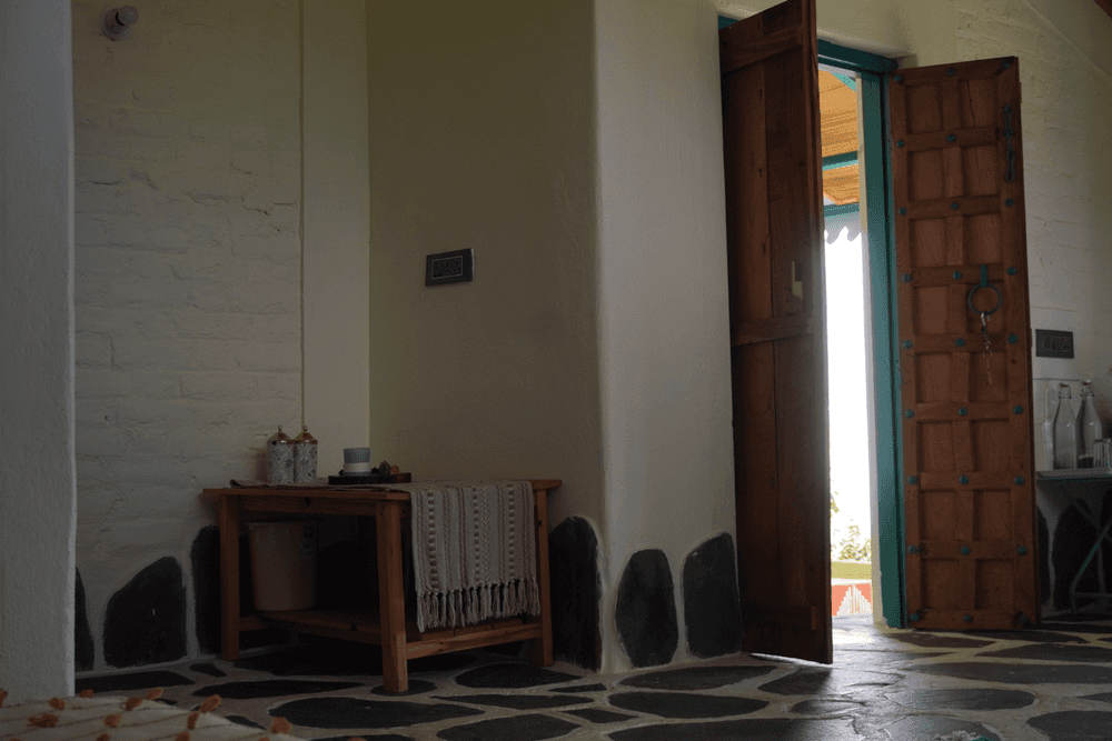 Side table and carved doors to the balcony