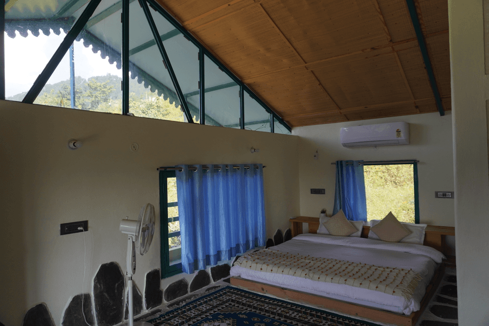 Bed and windows with hill views
