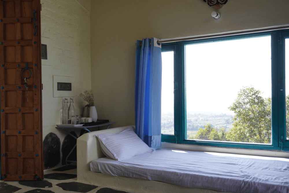 Daybed beside a large window looking out over the hills