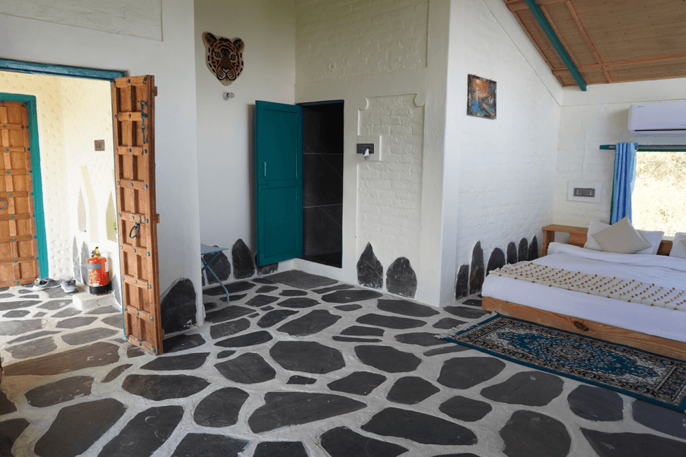 Wide view of the room with its stone floor and wooden doors