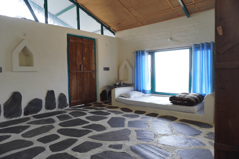 Daybed corner with a carved door and high windows