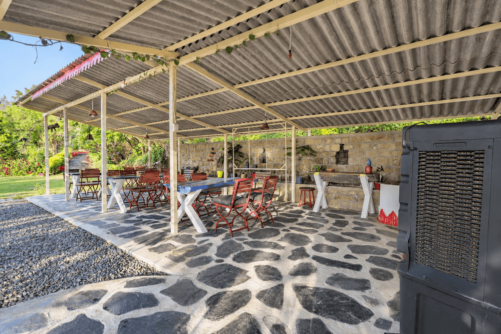 Covered outdoor dining pavilion with wooden tables